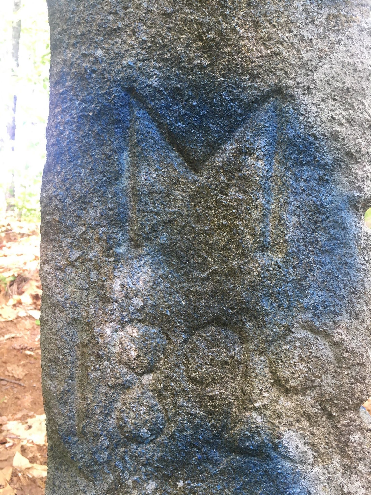 Close-up of pillar showing engraved letter M and, under it, 1898.
