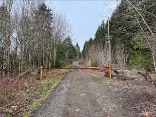 A metal gate controls access to a logging road into the park and adjacent lands.
